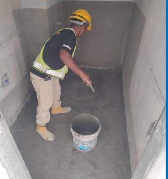 Worker applying waterproofing coating — OKG Waterproof & Coating